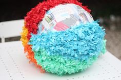 a colorful ball sitting on top of a white table