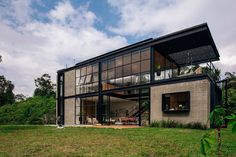 a modern house in the middle of a lush green field