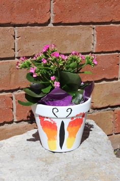 a potted plant with flowers painted on it