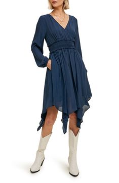 A fit-and-flare dress offers contemporary style with puffed balloon sleeves, a smocked waist, handy pockets and a flowy handkerchief hem. Slips on over head Surplice V-neck Long sleeves Partially lined 100% polyester Hand wash, dry flat Imported Model stats: 5'10" height, 32" bust, 25" waist, 36" hip. Model is wearing size Small. Casual Dresses With Elastic Billowy Sleeves, Billowy Chic Smocked Dress With Smocked Back, Chic Billowy Smocked Dress With Smocked Back, Flowy Midi-length Fall Dress, Flowy Midi-length Dress For Fall, Fall Midi Dress With Flowy Skirt, Flowy Fall Midi Dress, Billowy Long Sleeve Midi Dress With Smocked Back, Billowy Long Sleeve Midi Dress With Smocked Cuffs