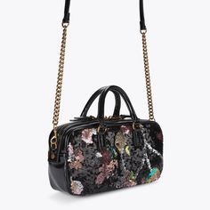 This Small Kensington Duffle Purse features a black exterior with sequin floral pattern across the front and back. There is an antiqued brass eagle head with crystals sat on the front5.9in (H), 10.6in (L), 2.7in (D)Strap length: 59.1inTwo top handlesFour antiqued brass feetAntiqued brass branded plate on the backInterior slip pocketCan fit phones up to 7inchesMaterial: LeatherStyle number: 3580909779 Black Embellished Top Handle Bag, Luxury Black Sequined Bags, Micro Bags, Swimming Bag, Cross Body Purse, Eagle Head, Bow Shoes, Shop Shoes, Black Exterior