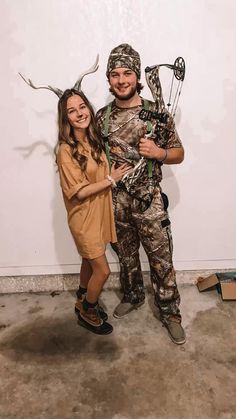 a man and woman dressed up as deer hunters