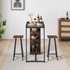 a small table with two stools in front of it and bottles on the shelf