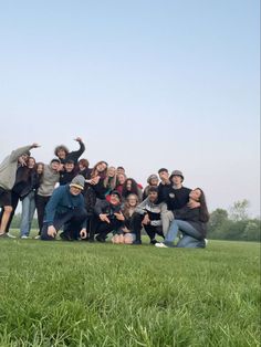 a group of people posing for a photo in the grass