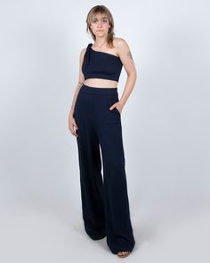 These are the ultimate wide leg palazzo pant. They are high-waisted and have pockets for optimum comfort and style. They look sleek for a business meeting, super cool at the studio, and really hot for a night out. PRODUCT DETAILS: - 60% Rayon, 33% Nylon, 7% Lycra- Moisture wicking and four-way stretch - Machine washable and dryer safe - MADE IN USA - Model: Talia is 5'4" is wearing a size Small View our shipping and returns policy We'd love to hear from you! Email hello@paridaez.com with any que Modern Wide Leg Party Bottoms, Summer Evening Wide Leg Pantsuit, Summer Evening Wide-leg Pantsuit, Wide Leg Pants For Date Night In Summer, Versatile High Waist Wide Leg Pants, Versatile High-waisted Wide Leg Pants, High Waist Wide Leg Pants For Date Night, Modern Wide-leg Evening Pants, Chic Solid Color Straight Leg Pantsuit