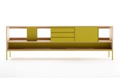 a yellow and green shelf sitting on top of a white floor