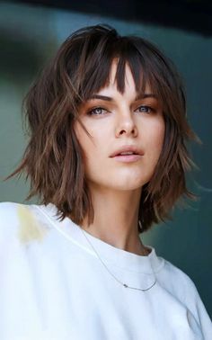 Dark brown short shaggy bob with layered texture, adding depth and movement