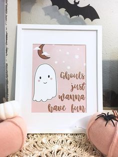 a pink and white halloween print with a ghost in the corner next to two pumpkins