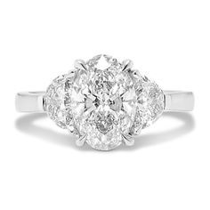 an oval cut diamond ring with three stone shoulders