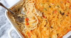 a casserole dish with noodles and vegetables in it, ready to be eaten