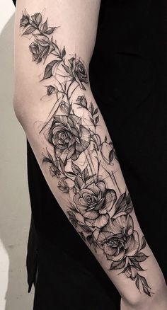 a woman's arm with flowers and leaves on the left side of her body