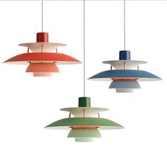 three different colored lamps hanging from the ceiling