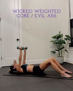 a woman is doing an exercise with two dumbbells on her chest and one arm behind her head