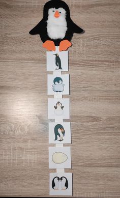 a penguin is sitting on top of some cards