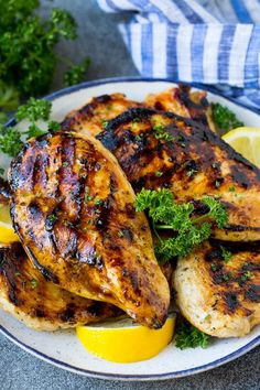 grilled chicken marinade on a plate with lemons and parsley