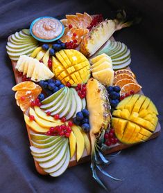 an assortment of fruit is arranged on a platter