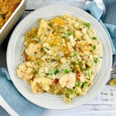 a white plate topped with chicken casserole next to a blue and white towel