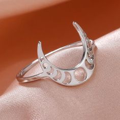 Let your style shine with this Crescent Moon Phases Witch Ring. Crafted from stainless steel and with a sleek 2mm width, this ring comes in a classic steel or gold color. Featuring a crescent moon and the different phases of the moon, this is an eye-catching piece that's perfect for everyday wear 🔮. Silver Celestial Metal Ring, Elegant Crescent Moon Charm Rings, Silver Moon Phase Midi Rings, Silver Midi Rings With Moon Phase, Silver Crescent Moon Phase Ring, Adjustable Crescent Moon Phase Ring, Witch Ring, Bohemian Style Rings, Moon Jewellery