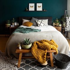 a bedroom with green walls and white bedding, pineapples on the end table