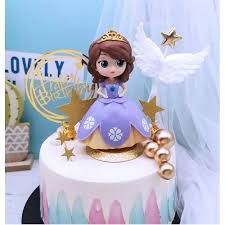 there is a cake that has a princess on it and stars around the top tier