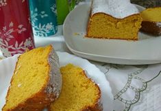 slices of cake sitting on plates next to cups