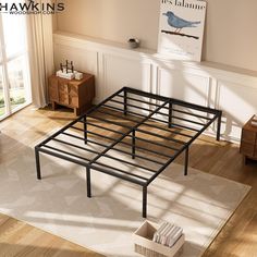 a metal bed frame sitting on top of a wooden floor next to a dresser and window