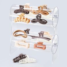 several pairs of wooden clips are in a clear display case on a white background with measurements for each pair