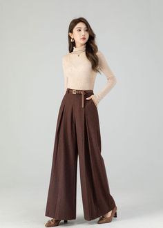 "Carefully crafted from luxurious wool, these full-length trousers provide the ultimate blend of fashion and warmth. Their flattering wide-leg design adapts to various occasions, and the deep chestnut brown shade exudes timeless sophistication. Whether you're heading to the office or a festive gathering, these wool pants ensure you stay stylish and snug. Embrace the beauty of the season with this must-have piece designed to keep you fashion-forward and cozy. DETAILS: * 30% wool blend, 40% fiber and polyester, 40% nylon * Polyester Lining * Two side pockets * Zipper and button front closure * Pleated detail * High waisted pants * Wide leg pants * Perfect for Winter, autumn * Dry clean MODEL SIZE Bust 85 cm(33.4\") Waist 67 cm(26.7\") Height 168cm (5' 6\") She wears size XS CUSTOM MADE SERVI A Line Trousers, Winter Trousers Women, Pleated Pants For Women, Wide Leg Pants For Fall, Wool Pants Women, Wool Trousers Women Outfit, Wide Leg Brown Pants Outfit, Brown Trousers Women, Chocolate Brown Pants Outfit