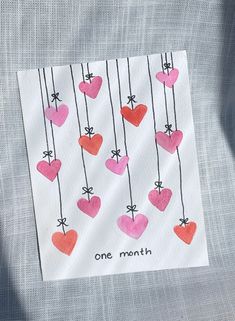 a piece of paper with hearts hanging from it