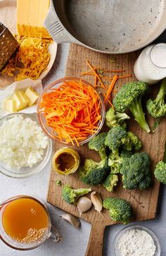 broccoli, carrots, onions, cheese and other ingredients on a cutting board