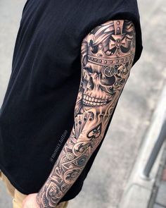 a man with a skull tattoo on his arm