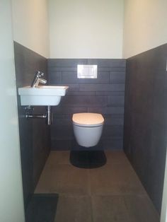 a toilet and sink in a small room