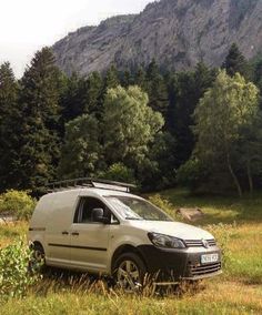 a van parked in the middle of a field