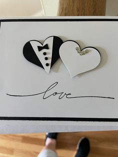 a card with two paper hearts attached to it