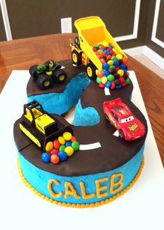 a birthday cake with cars and trucks on it