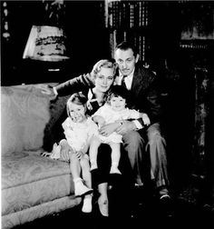 an old black and white photo of a family sitting on a couch