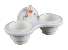 two cup holders with an orange and white toothbrush holder in the middle, on a white background