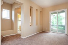 an empty living room with sliding glass doors