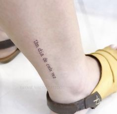 a woman's foot with a tattoo on it that reads, and the words i am