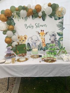 an animal themed baby shower with balloons and decorations