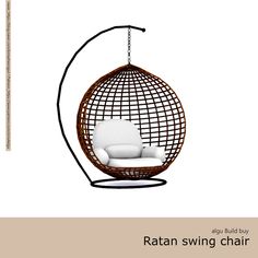 the rattan swing chair is hanging from a metal rod and has a white cushion on it