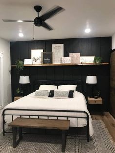 a bed room with a neatly made bed and a wooden shelf on the wall above it