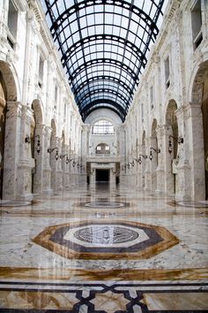 the inside of a building with marble floors and arches