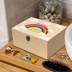 a wooden box sitting on top of a counter next to a hair brush and comb