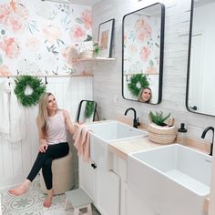 a white bathroom with two sinks and mirrors