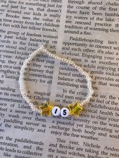 a beaded bracelet with the number thirteen on it and two stars attached to it