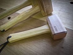 a couple of sticks sitting on top of a wooden floor next to a box and scissors