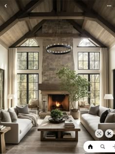 a living room filled with furniture and a fire place in the middle of a room