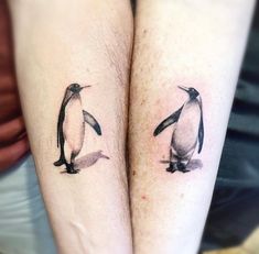 two penguin tattoos on both legs