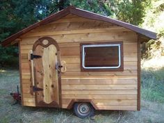 a small wooden house with a door and window